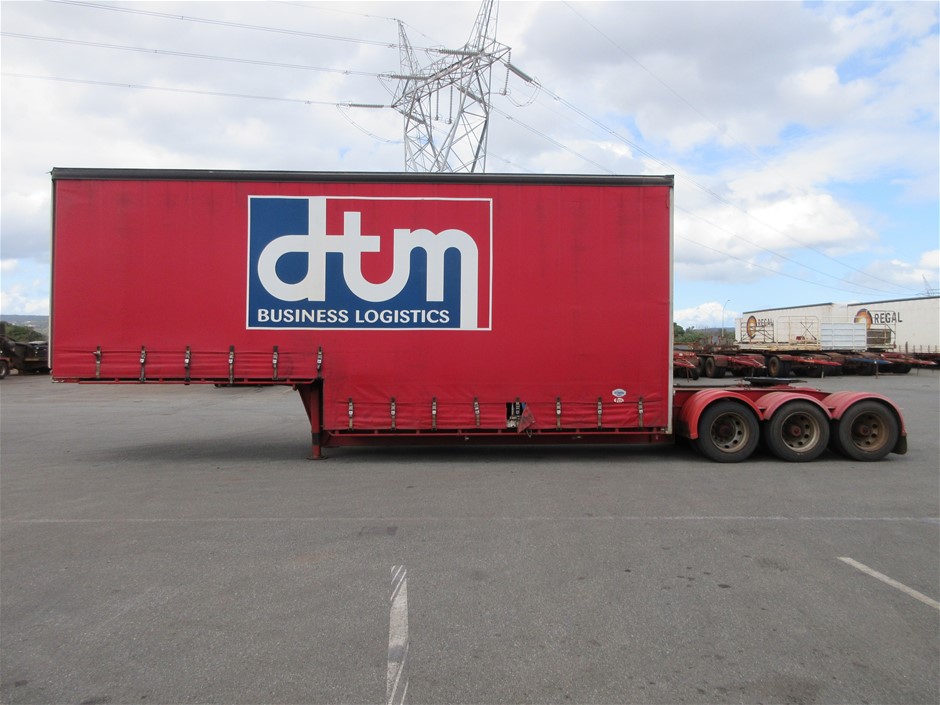 Rash Vest Made With Water Reactive Fabric Showing Dolphin Print When Wet