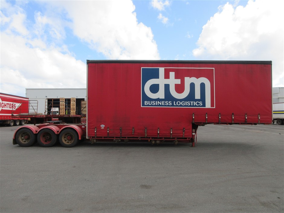 Rash Vest Made With Water Reactive Fabric Showing Dolphin Print When Wet