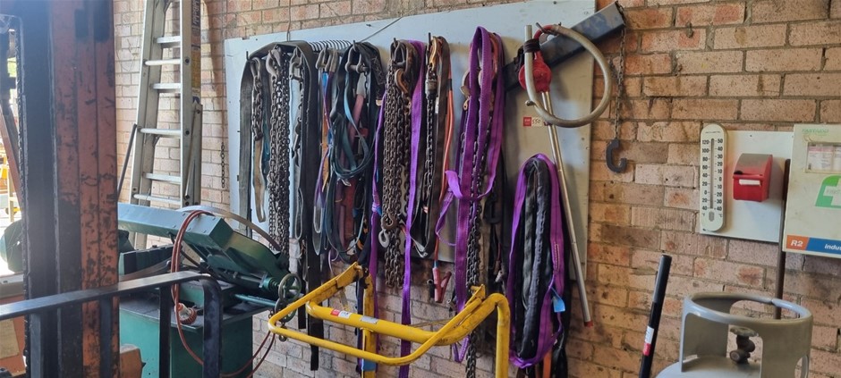 Large quantity of chains and lifting straps wall mounted