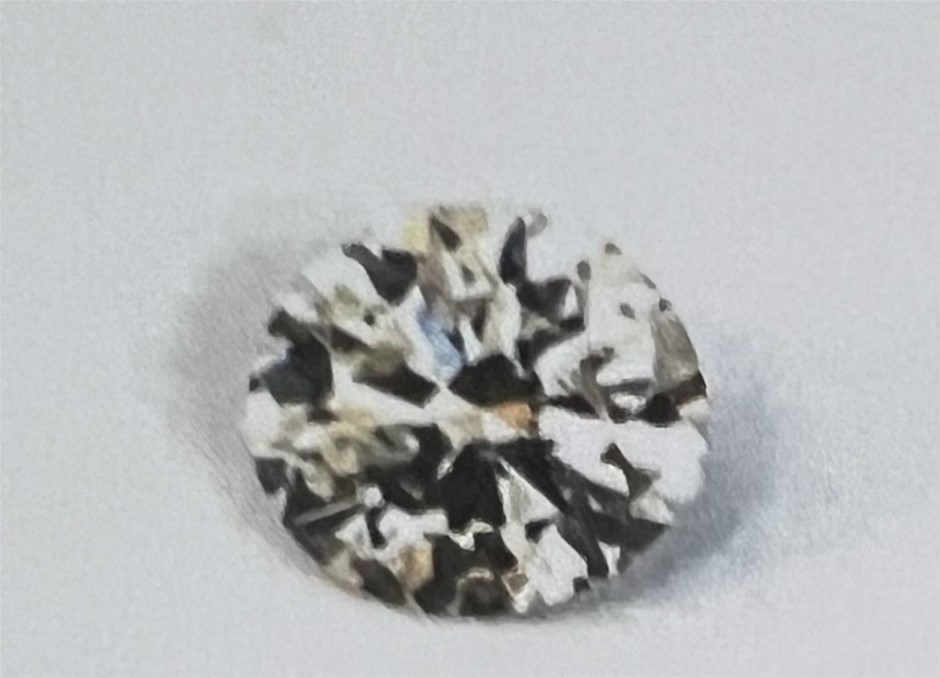 0.19 carat faint brown round diamond val:$512