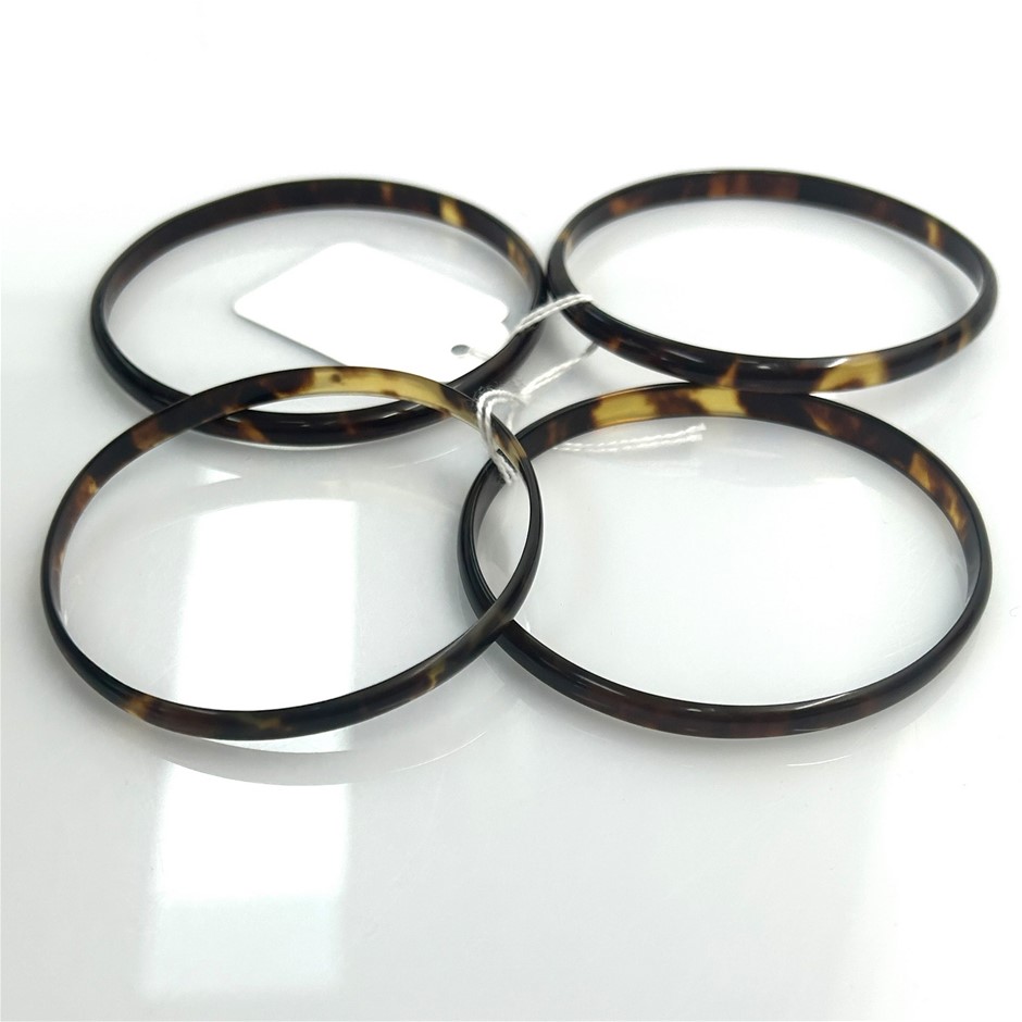Set of four tortoiseshell bangles featuring slim polished
