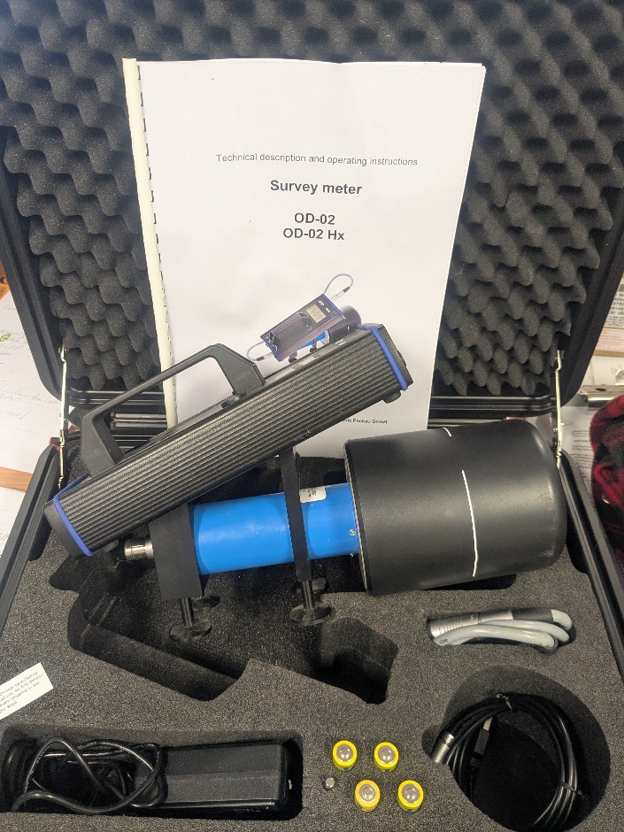 Radiation survey meter with carry case and accessories.