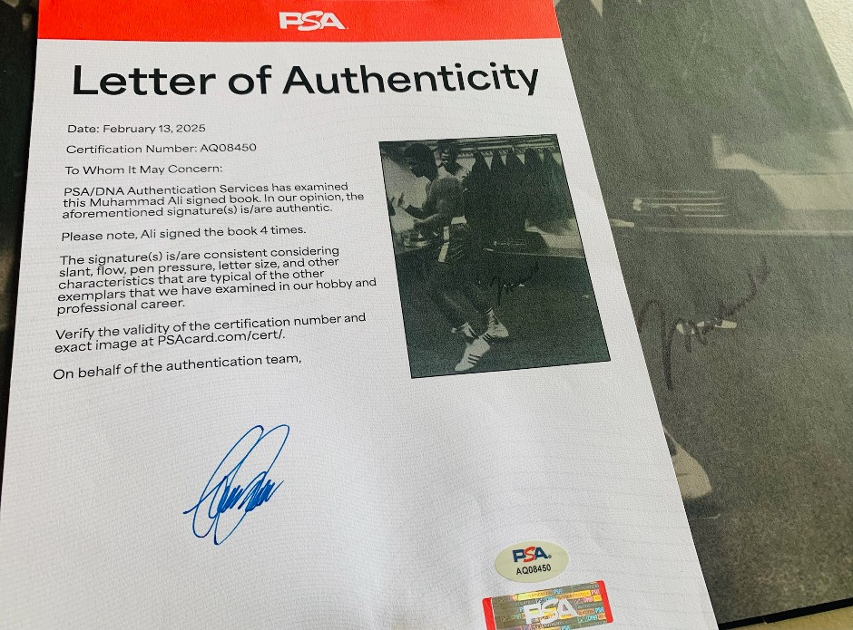 <p>Muhammad Ali Signed book - PSA/DNA authentication</p>